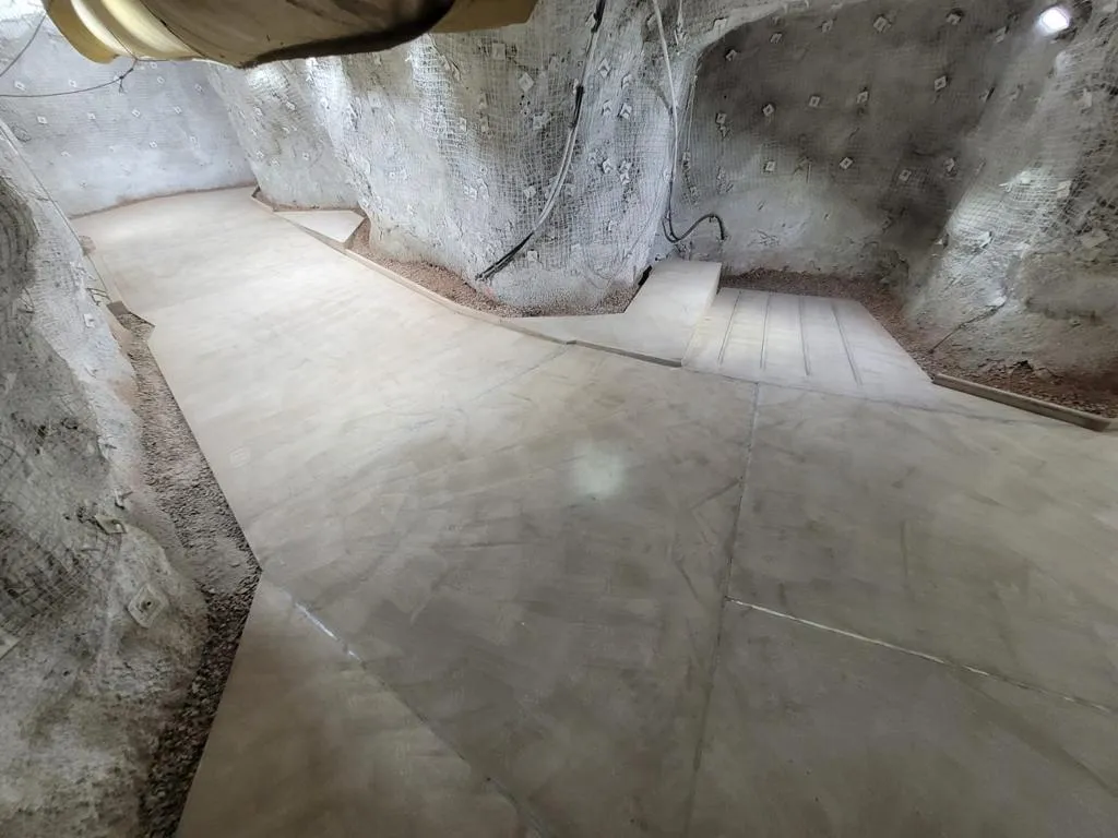 Underground fuel bay with poured concrete floor and mesh-supported rock walls at the 1700 level