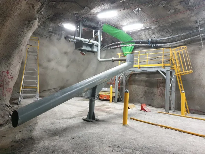 Underground mine service platform with steel pipeline, ventilation duct and yellow access platform